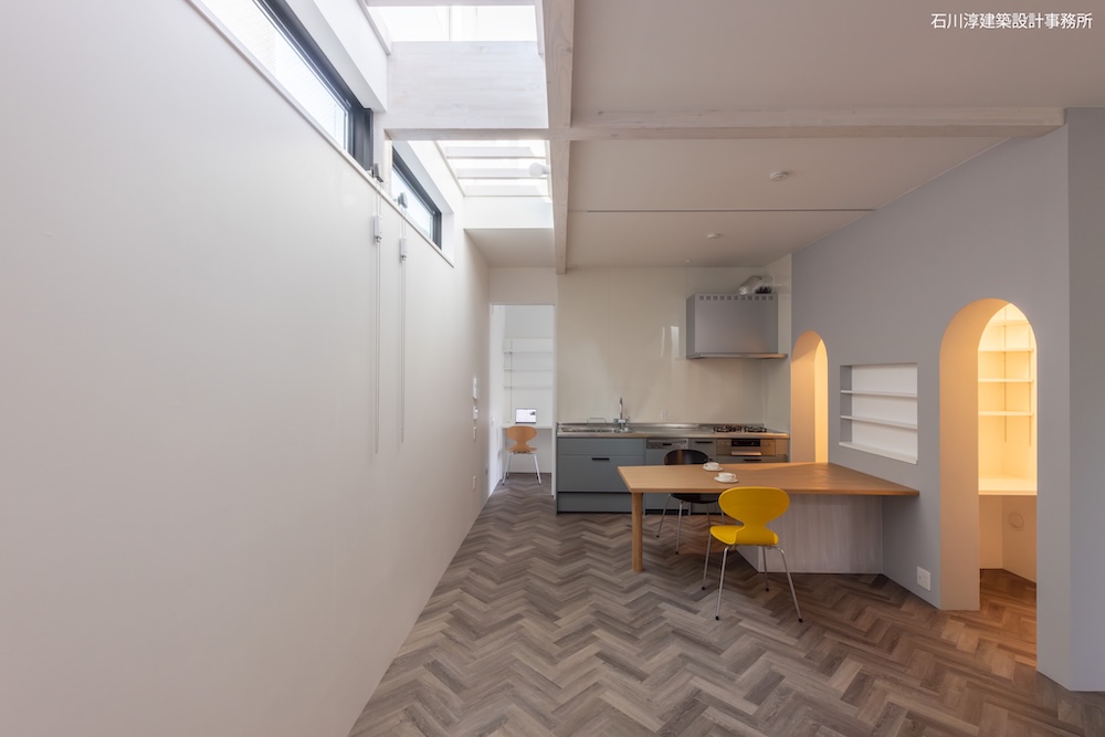 南側の透明天井から採光。キッチン左の開口奥はバイク収納室